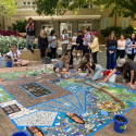 Students contribute to a temporary mosaic installation